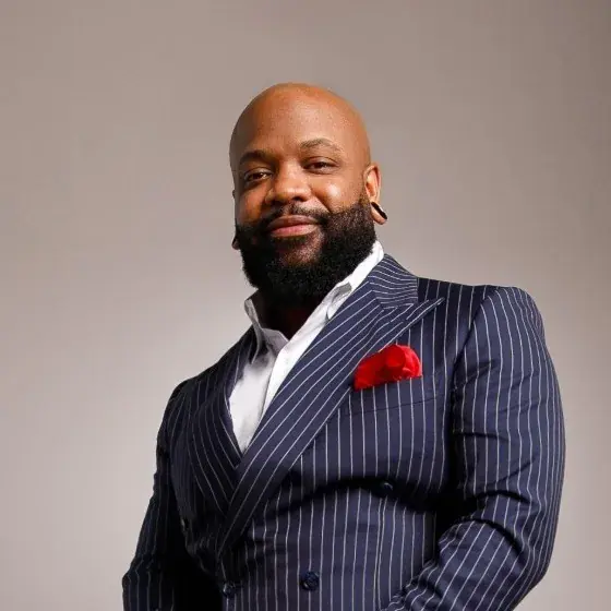Robert Hulett, licensed insurance broker, in a navy pinstripe suit